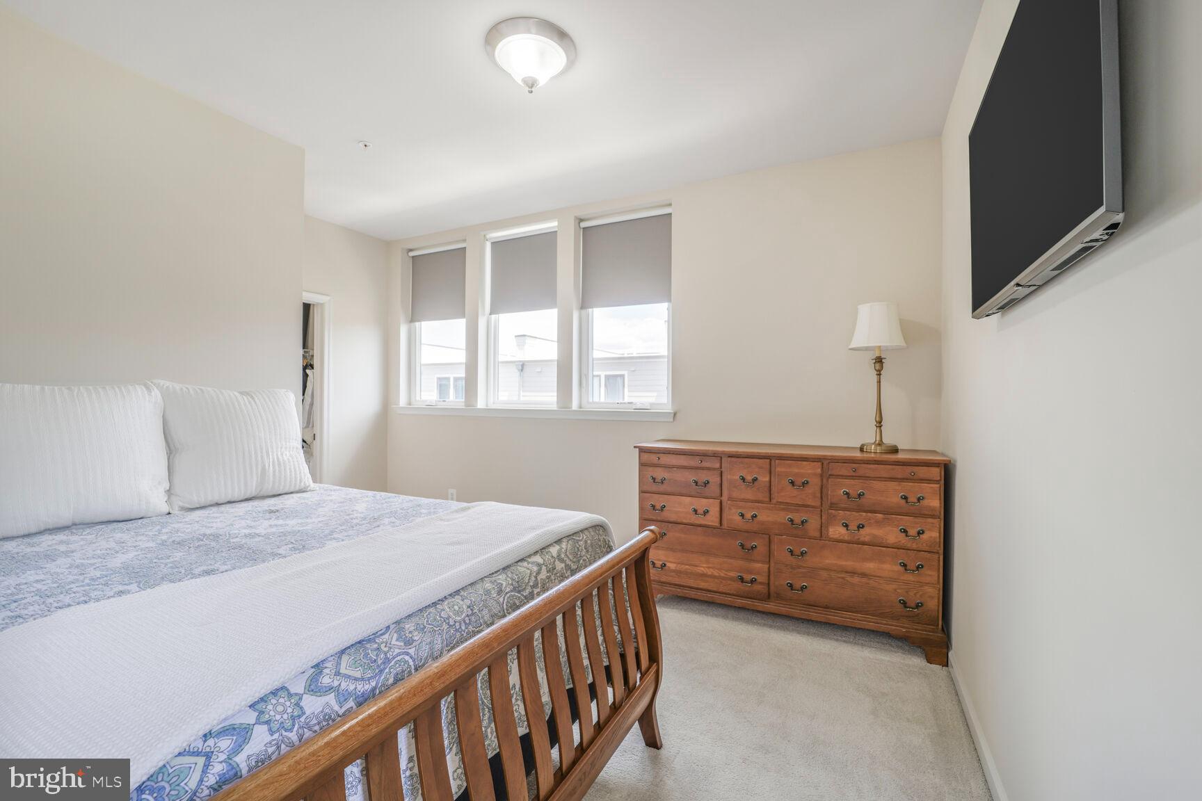 515 Riversail Lane, Unit 430 Oxon Hill, MD 20745 - Photo 29 of 54 a bedroom with a bed dresser and a window