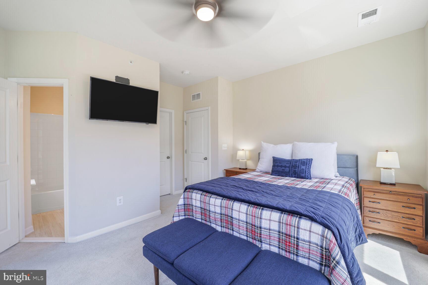 515 Riversail Lane, Unit 430 Oxon Hill, MD 20745 - Photo 31 of 54 a bedroom with a bed and a television