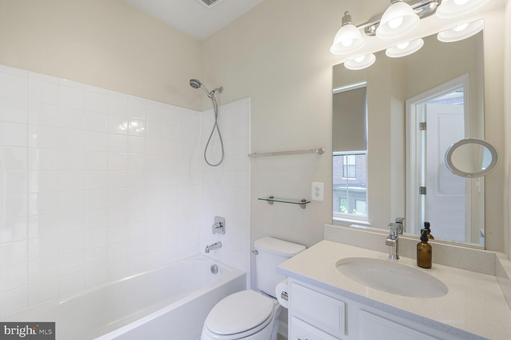 515 Riversail Lane, Unit 430 Oxon Hill, MD 20745 - Photo 33 of 54 a bathroom with a sink a toilet a mirror and shower