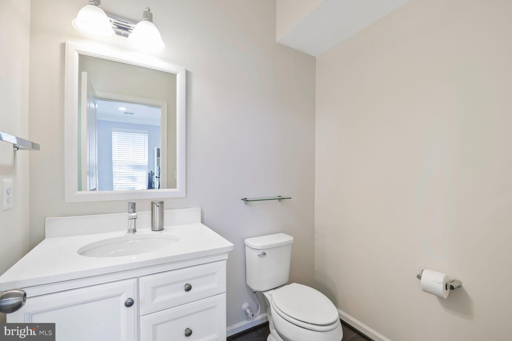 515 Riversail Lane, Unit 430 Oxon Hill, MD 20745 - Photo 35 of 54 a bathroom with a sink a toilet and a mirror