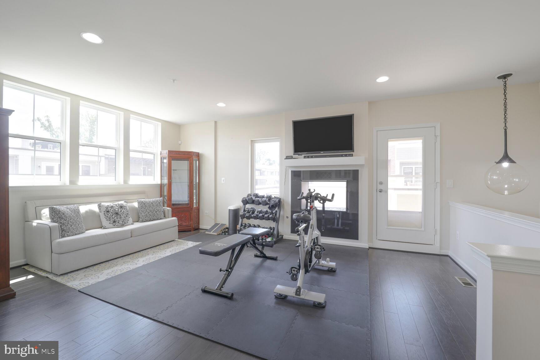 515 Riversail Lane, Unit 430 Oxon Hill, MD 20745 - Photo 37 of 54 a living room with furniture and a flat screen tv