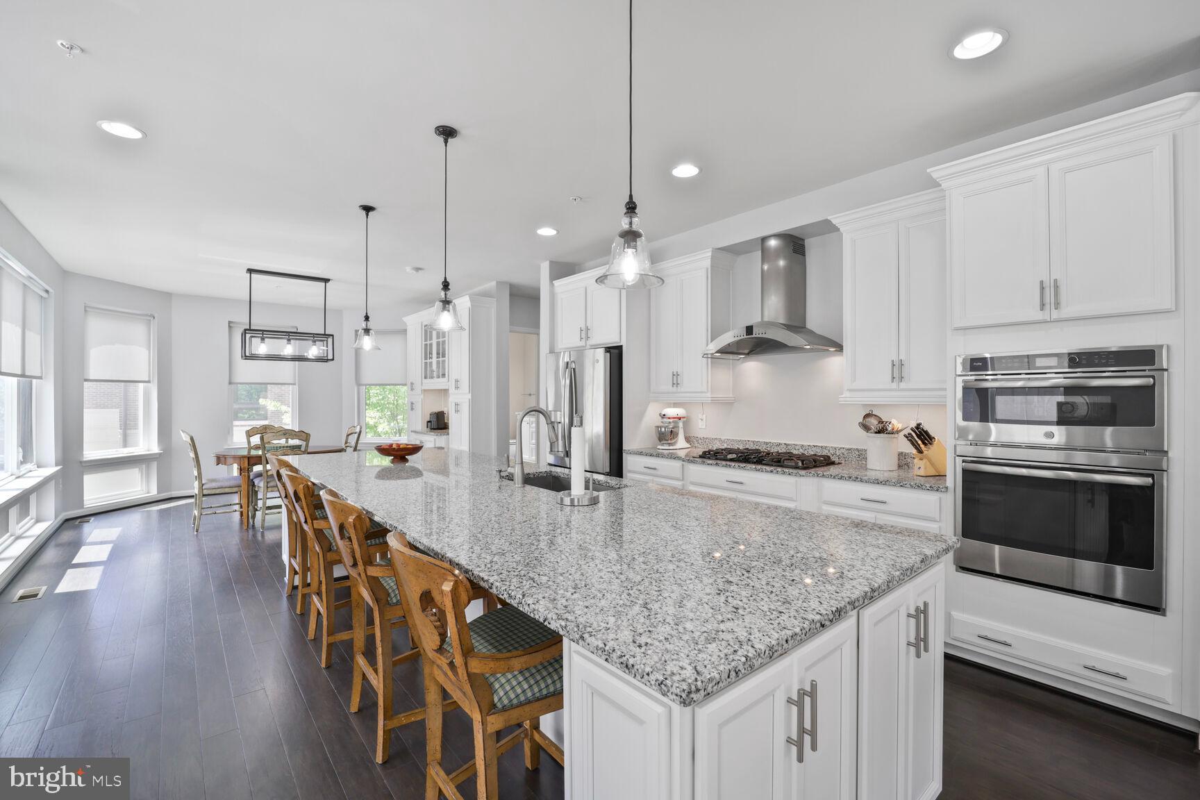 515 Riversail Lane, Unit 430 Oxon Hill, MD 20745 - Photo 7 of 54 a kitchen with stainless steel appliances granite countertop a stove top oven a sink refrigerator and cabinets