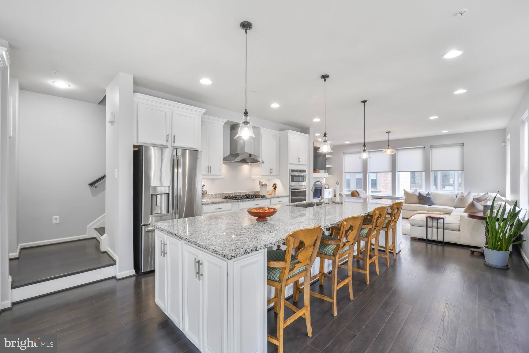 515 Riversail Lane, Unit 430 Oxon Hill, MD 20745 - Photo 10 of 54 a kitchen with stainless steel appliances granite countertop a kitchen island a stove a table and chairs