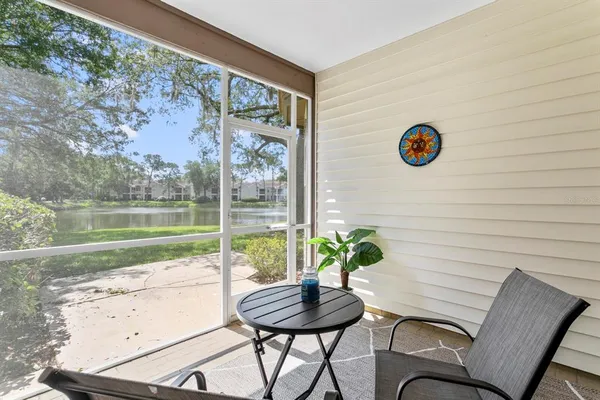 a view of a chairs and table in patio with a yard