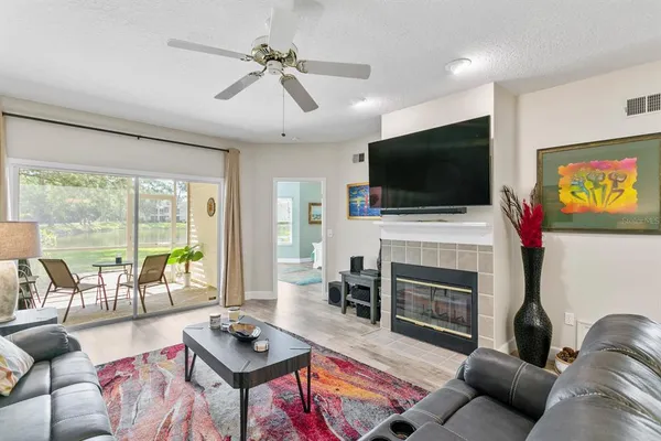 a living room with furniture a flat screen tv and a fireplace