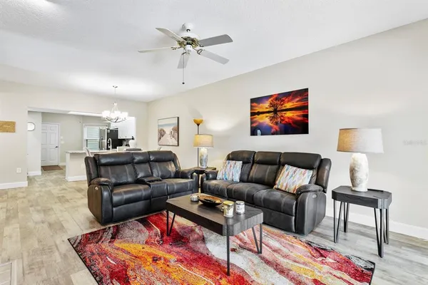a living room with furniture a rug and a lamp