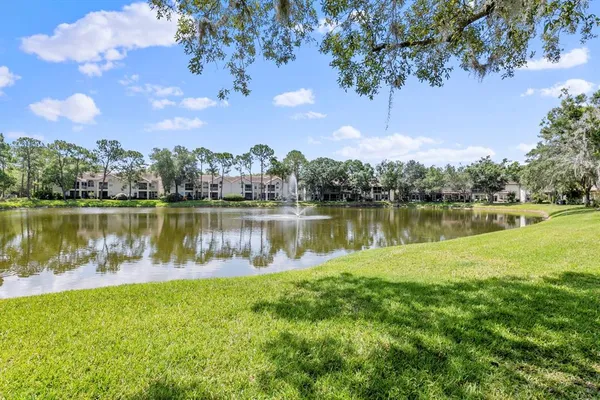 a view of a lake with houses in the back