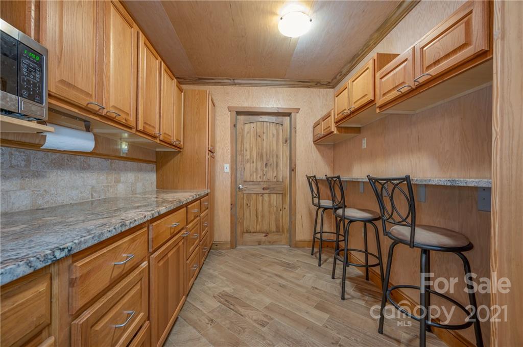 160 Fagan Drive Inman, SC 29349 - Photo 5 of 45 a kitchen with granite countertop cabinets and wooden floor