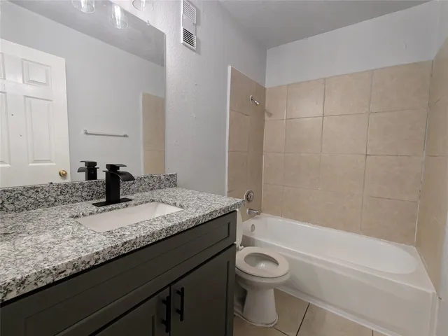 an empty room with white walls and tiles