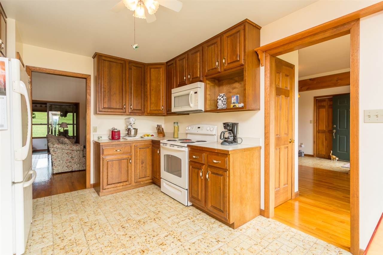 72 Greenfield Road Fishersville, VA 22939 - Photo 21 of 50 a kitchen with granite countertop a stove a sink and a refrigerator