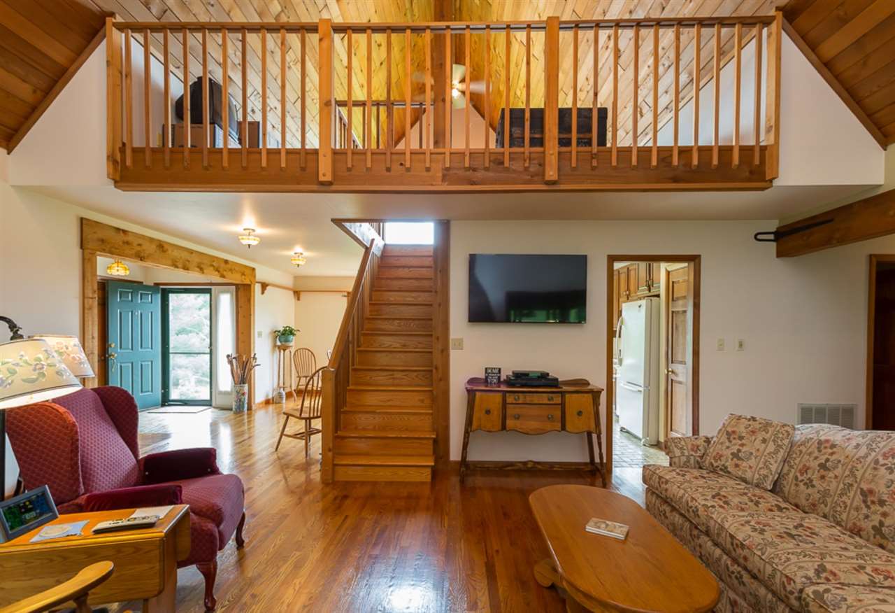 72 Greenfield Road Fishersville, VA 22939 - Photo 32 of 50 a living room with furniture a flat screen tv and floor to ceiling window