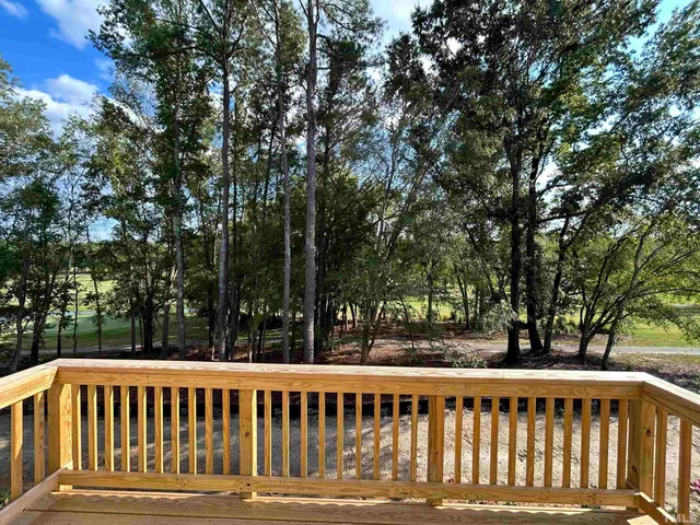 a view of a wooden deck and a yard