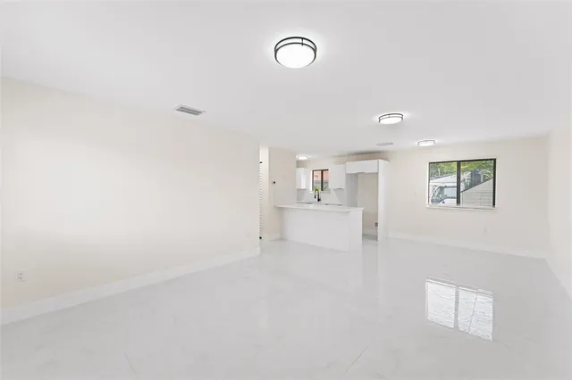 a view of a kitchen with white cabinets