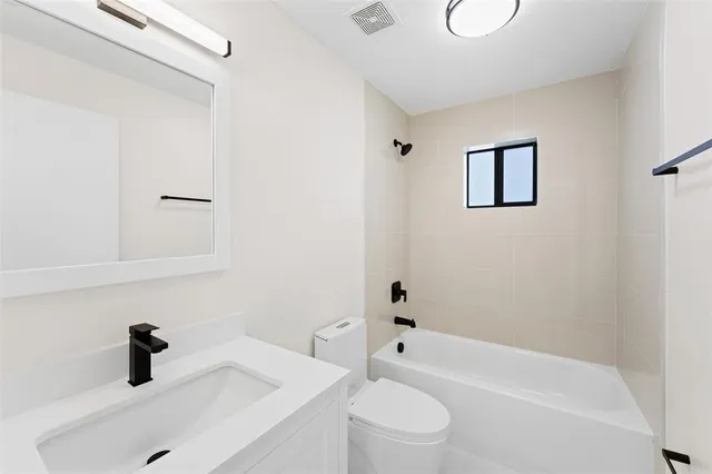 a bathroom with a sink a toilet and a bathtub