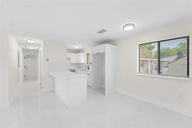 a large white room with white walls and window