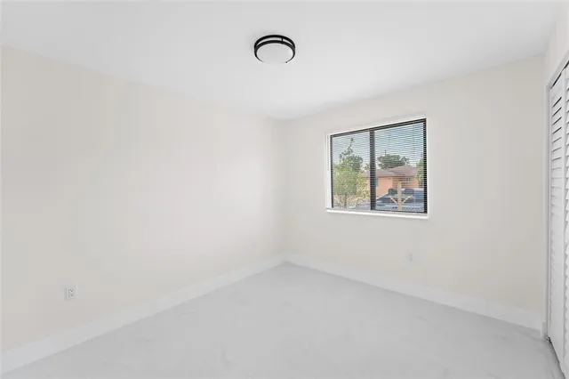 a view of an empty room with windows