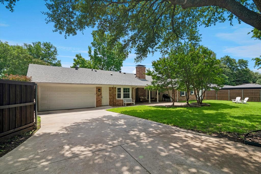 11439 Rosser Road Dallas, TX 75229 - Photo 32 of 35 a front view of a house with a yard and trees