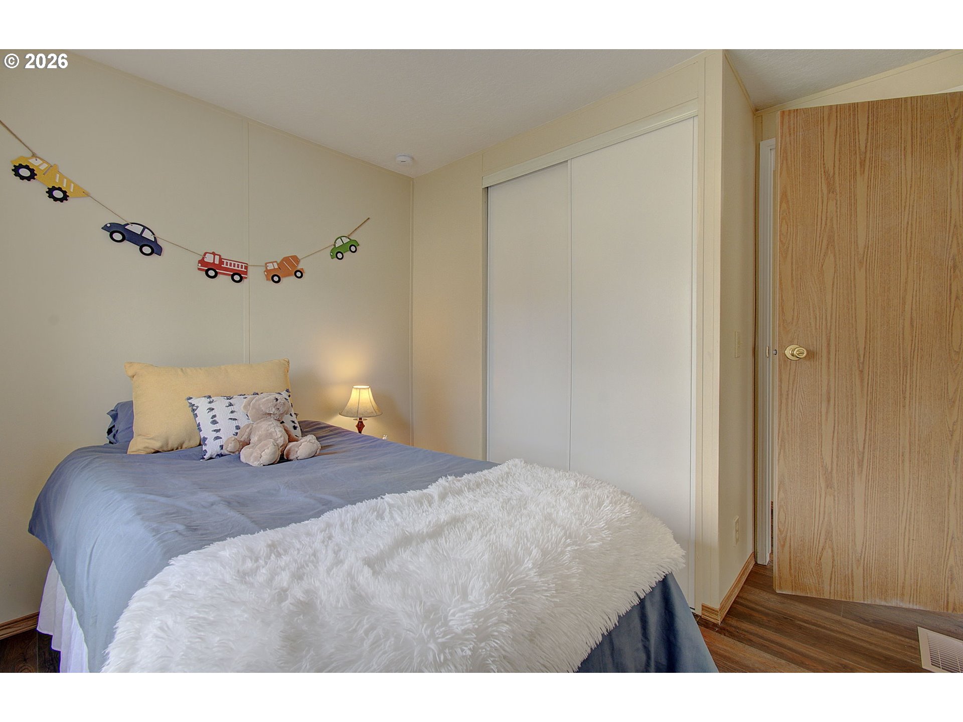 15619 Northeast Caples Road, Unit 150 Brush Prairie, WA 98606 - Photo 15 of 28 a bedroom with a bed and a cabinets