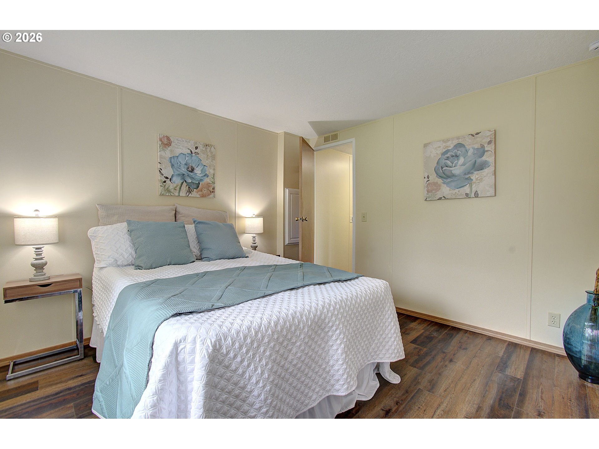 15619 Northeast Caples Road, Unit 150 Brush Prairie, WA 98606 - Photo 21 of 28 a bedroom with a bed and a painting on the wall
