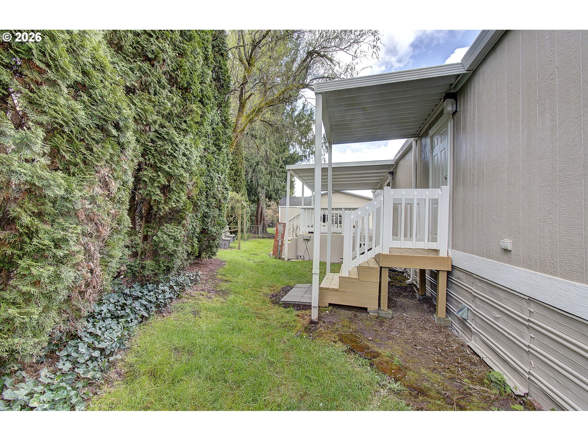 15619 Northeast Caples Road, Unit 150 Brush Prairie, WA 98606 - Photo 24 of 28 a view of a house with backyard and sitting area