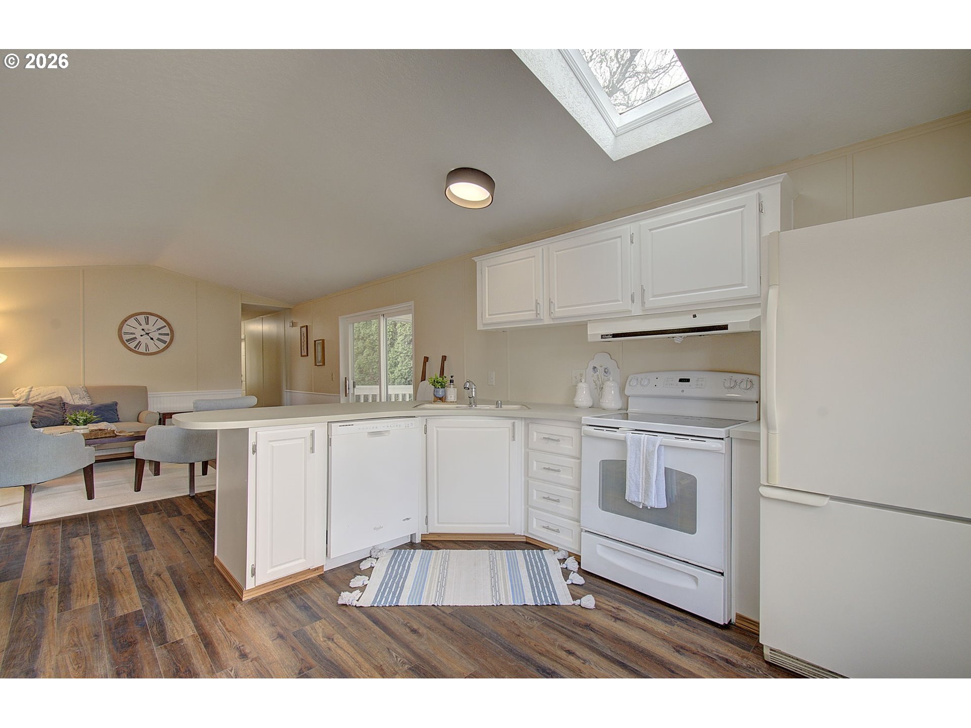 15619 Northeast Caples Road, Unit 150 Brush Prairie, WA 98606 - Photo 9 of 28 a kitchen with a refrigerator and white cabinets