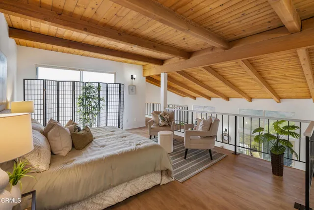 a bedroom with furniture and wooden floor
