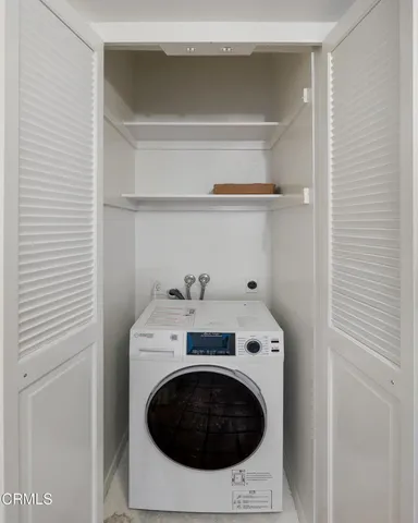 a bedroom with bed and a large window