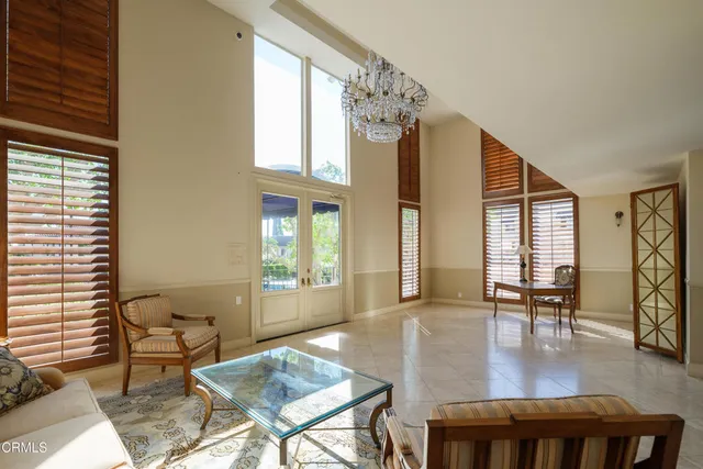 a living room with furniture and large windows