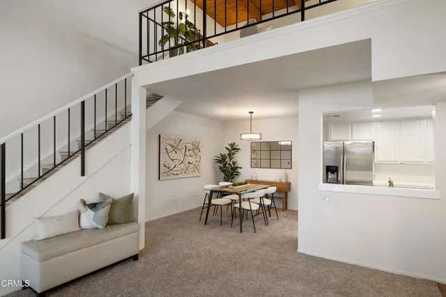 a living room with furniture and kitchen view