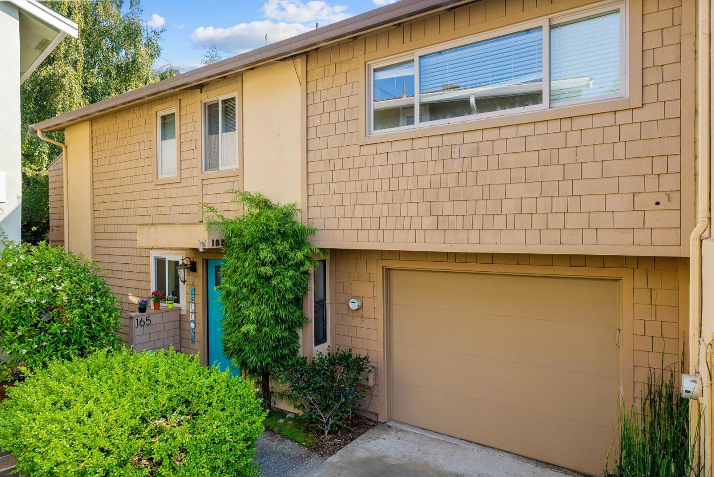 a view of a house with brick walls and plants