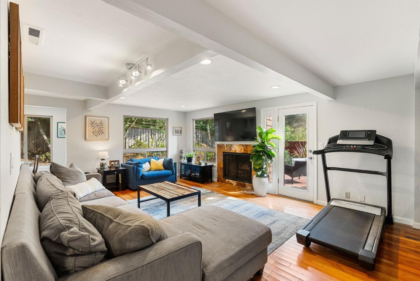 165 Bar Harbor Court Aptos, CA 95003 - Photo 5 of 37 a living room with furniture a flat screen tv and a fireplace