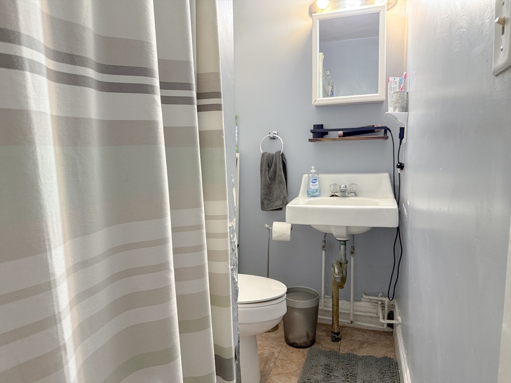173 Elm Street, Unit 2 Braintree, MA 02184 - Photo 13 of 20 a bathroom with a sink toilet and shower