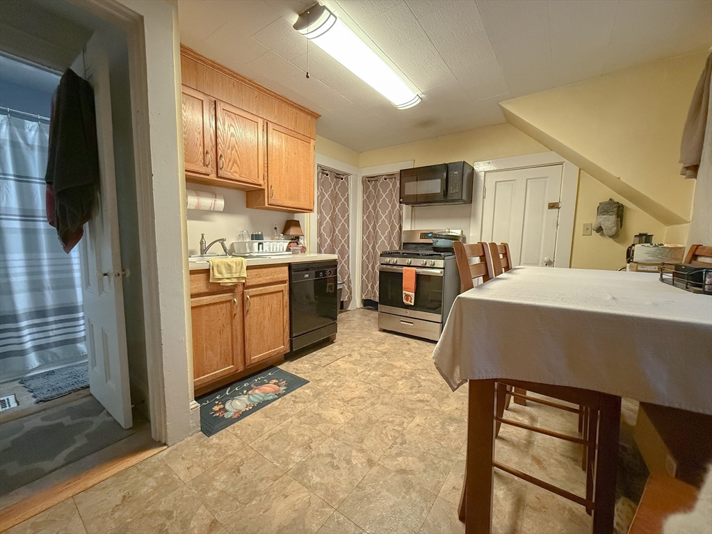 173 Elm Street, Unit 2 Braintree, MA 02184 - Photo 17 of 20 a kitchen with kitchen island a stove a sink a refrigerator and a refrigerator