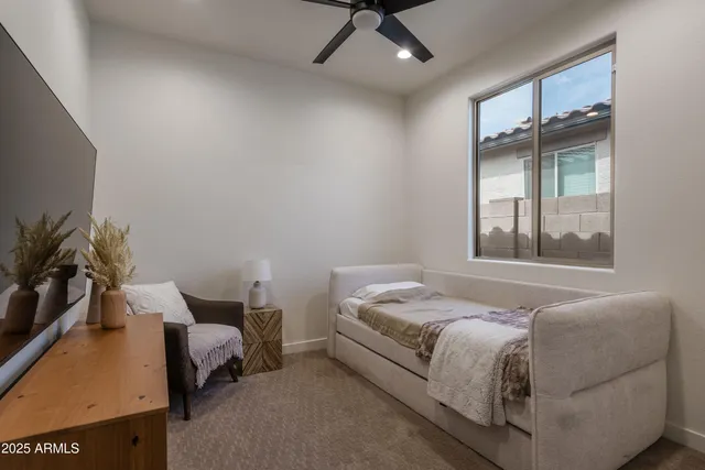 a bedroom with a bed window and couch