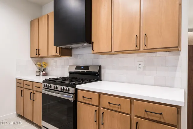 a kitchen with stainless steel appliances a stove a microwave and cabinets