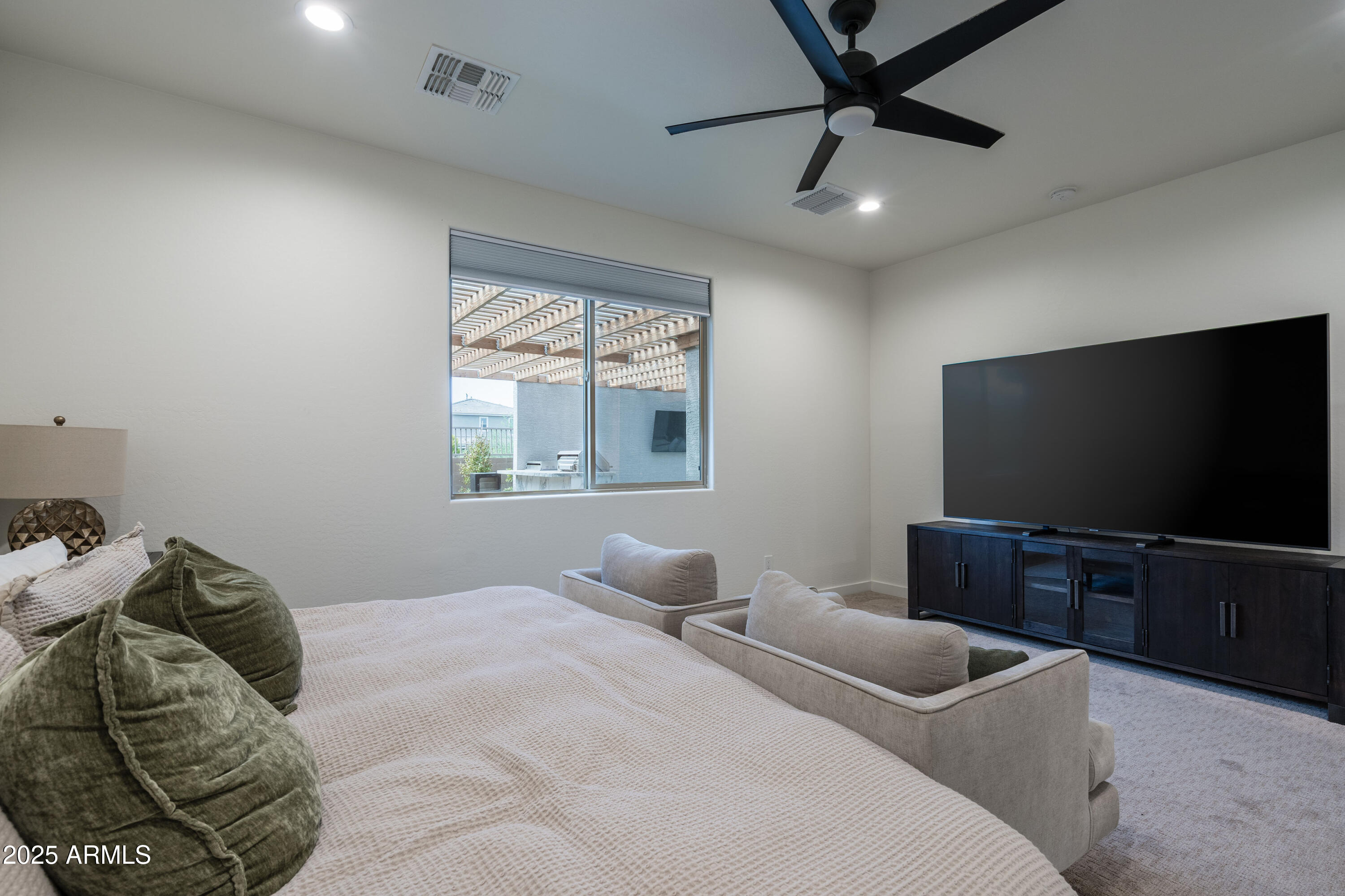 18365 West Ewers Drive Surprise, AZ 85374 - Photo 9 of 18 a bedroom with a bed and a flat screen tv