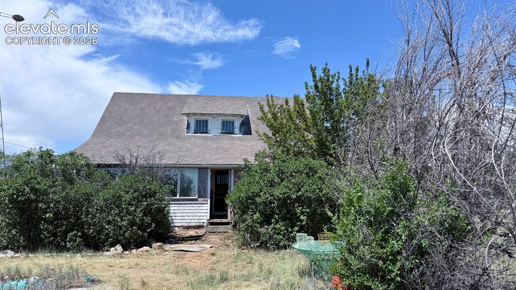 3380 Curtis Road Peyton, CO 80831 - Photo 2 of 13 Single-story residence featuring a gambrel roofline and dormer windows