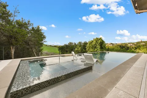 a view of swimming pool with a lounge chair