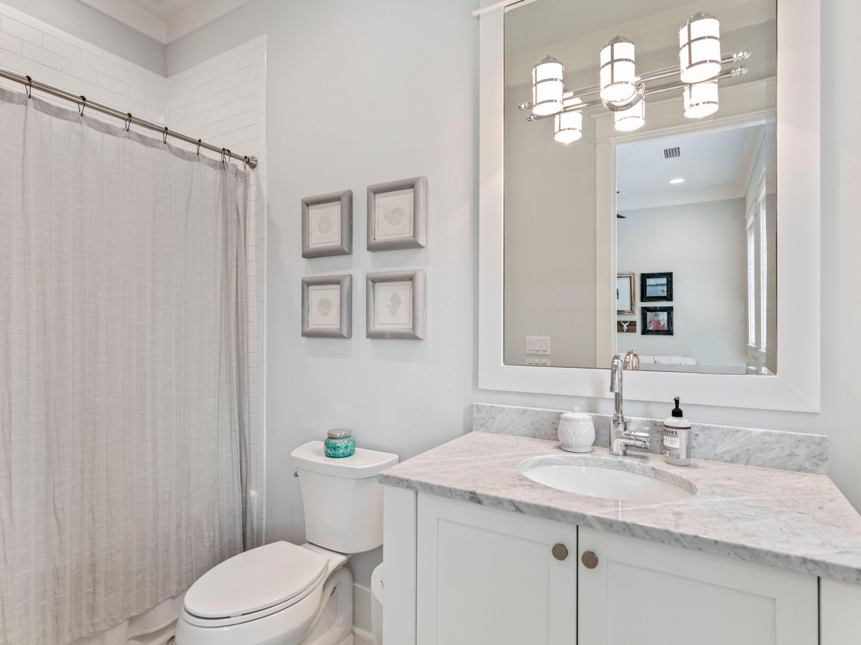 193 Splash Drive Inlet Beach, FL 32461 - Photo 35 of 43 a bathroom with a granite countertop sink toilet a mirror a vanity and shower