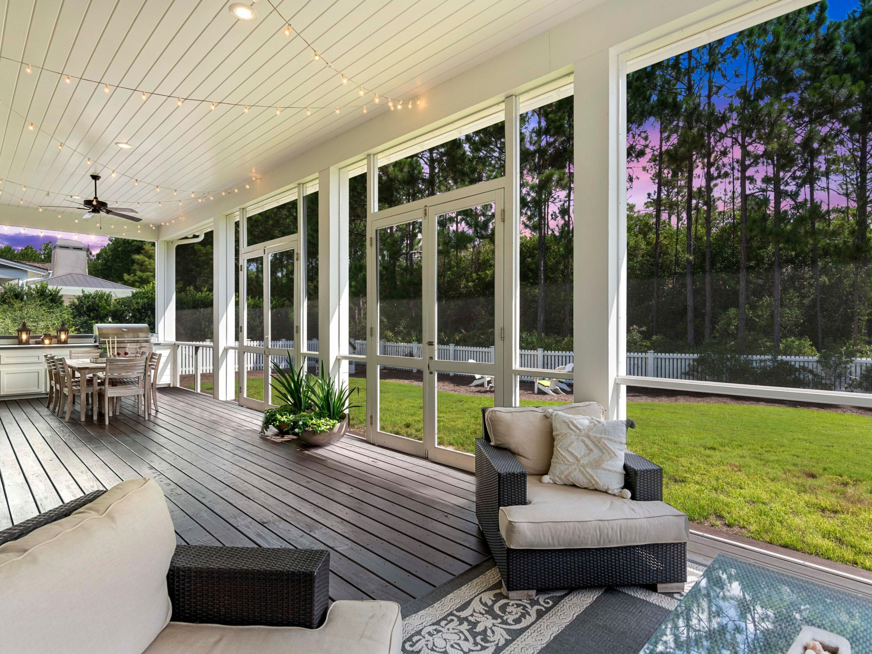193 Splash Drive Inlet Beach, FL 32461 - Photo 6 of 43 a view of a patio with couches potted plants and floor to ceiling window