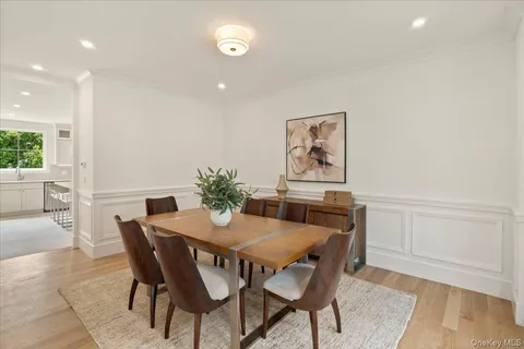 a dining room with furniture and wooden floor
