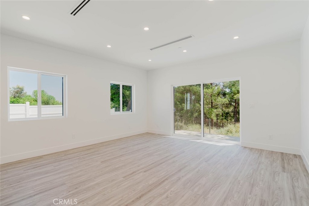 17846 Rinaldi Street Granada Hills, CA 91344 - Photo 6 of 34 an empty room with wooden floor and windows