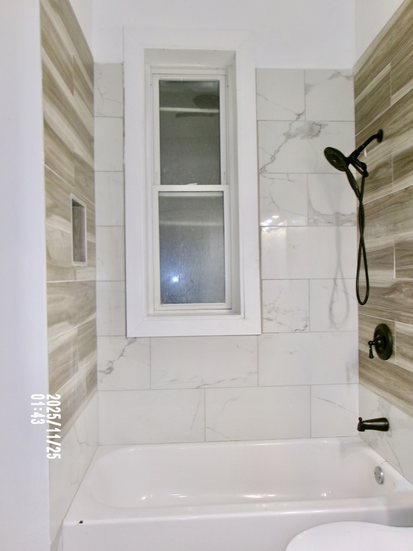 2852 East 91st Street, Unit 2 Chicago, IL 60617 - Photo 12 of 22 a bathroom with a bathtub