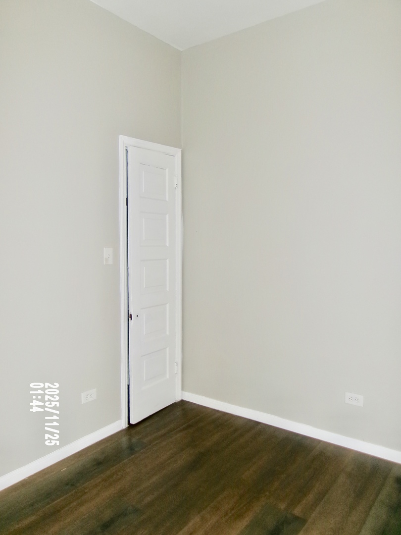 2852 East 91st Street, Unit 2 Chicago, IL 60617 - Photo 14 of 22 a view of an empty room with wooden floor