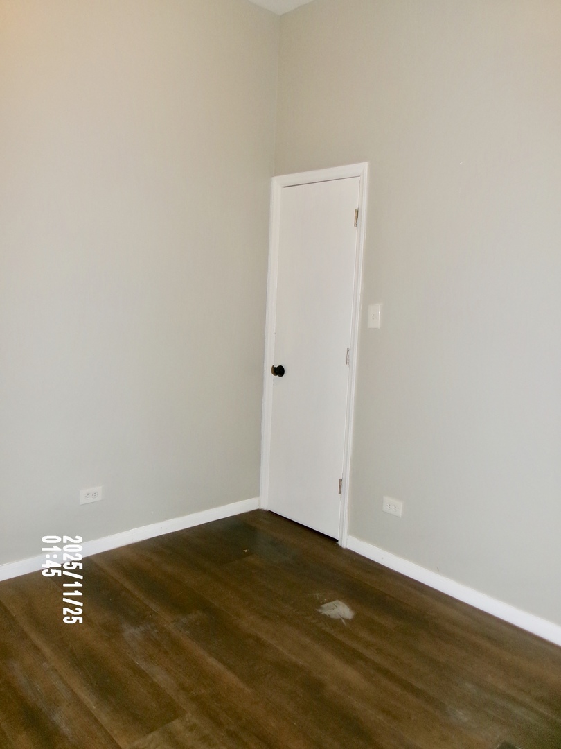 2852 East 91st Street, Unit 2 Chicago, IL 60617 - Photo 17 of 22 an empty room with wooden floor