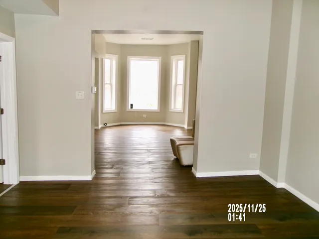 a view of hallway with wooden floor
