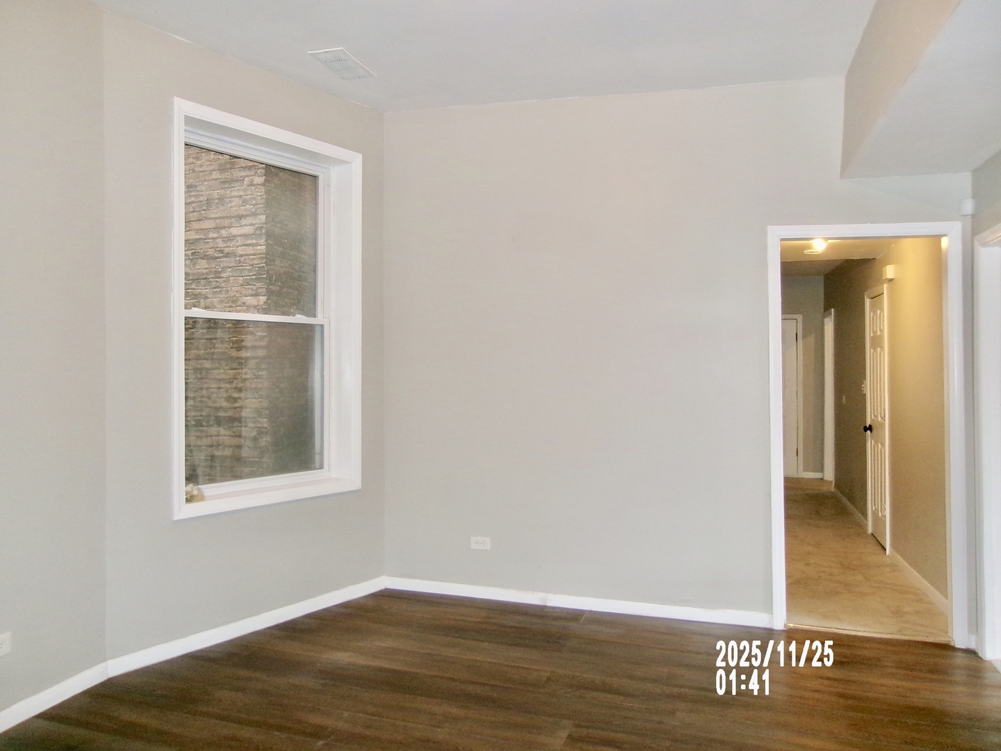 2852 East 91st Street, Unit 2 Chicago, IL 60617 - Photo 6 of 22 a view of an empty room with wooden floor and a window