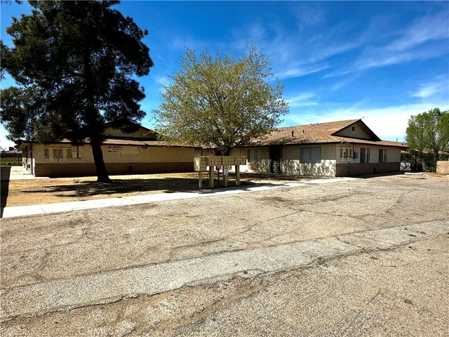 a view of a house with snow on the road
