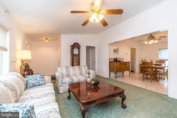 a living room with furniture a table and a chandelier