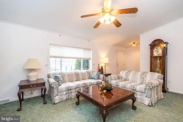a living room with furniture a lamp and a chandelier